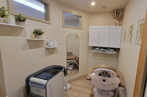 The image shows an interior view of a spa room with a dental chair and equipment, indicating a dental or medical treatment setting.